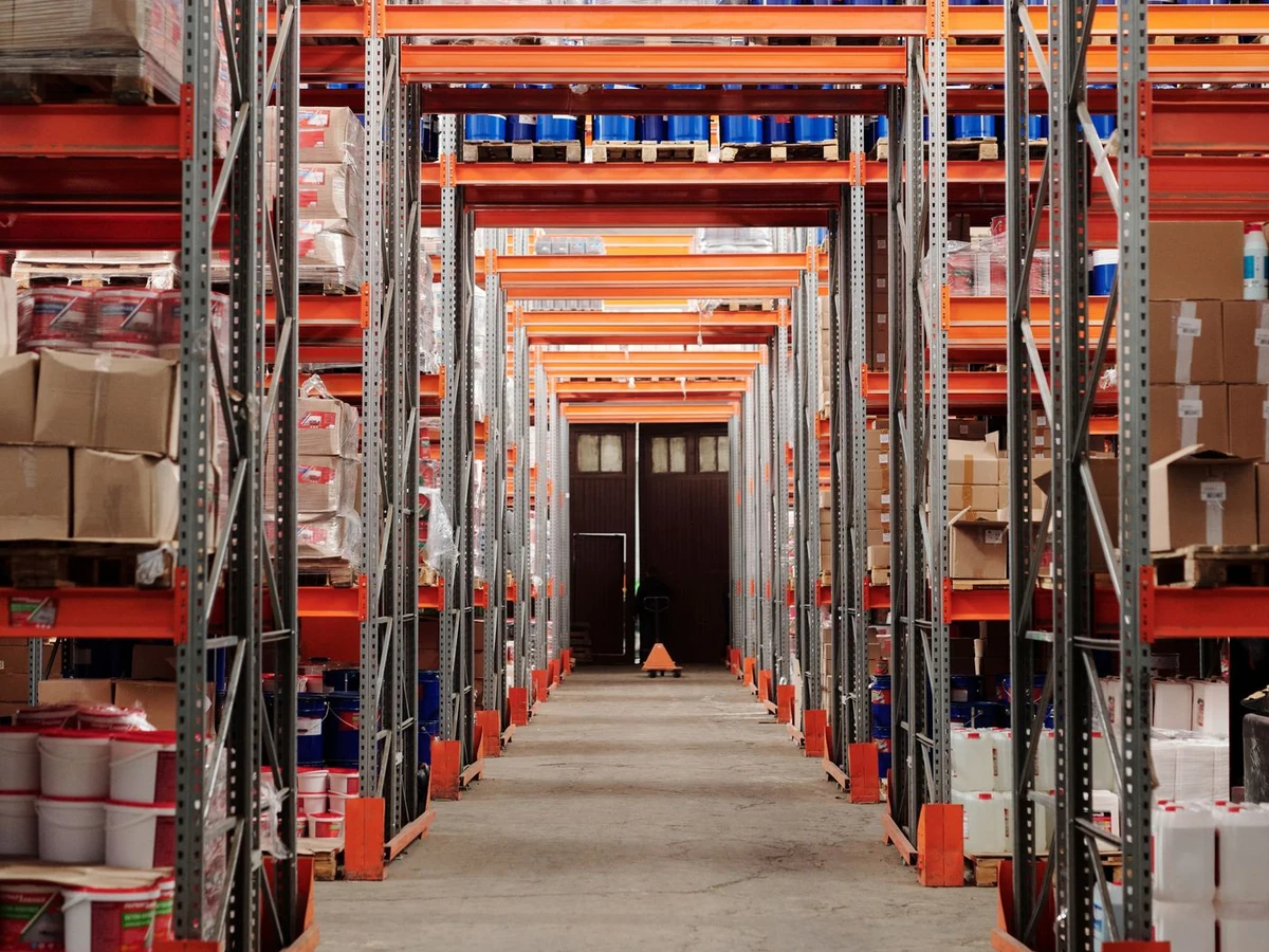 Stock photograph of a warehouse aisle with stocked pallet racks
